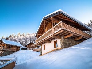 a log cabin in the snow with snow covered at Chalet Les Avanchers-Valmorel, 5 pièces, 8 personnes - FR-1-356-378 in Les Avanchers