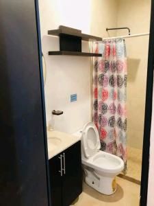 a bathroom with a toilet and a shower curtain at Loft estudio centrico in Ciudad del Carmen