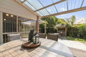 a table with a statue of a bird on top of it at Peaceful Retreat Surf Side Pet Friendly Outside Only in Inverloch