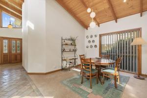 a dining room with a table and chairs at Peaceful Retreat Surf Side Pet Friendly Outside Only in Inverloch