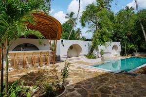 a villa with a swimming pool and a resort at Terra Resort in Ahangama