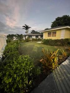 a house with a yard with plants in front of it at Wally's Haven in Nassau