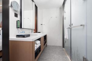 a bathroom with a sink and a shower at Hampton by Hilton Wuhan Optics Valley in Wuhan