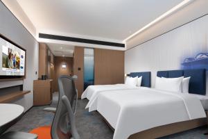 Ένα ή περισσότερα κρεβάτια σε δωμάτιο στο Hampton by Hilton Wuhan Optics Valley