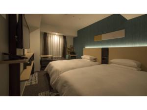 a hotel room with two beds and a window at Tmark City Hotel Sapporo Odori - Vacation STAY 85615v in Sapporo