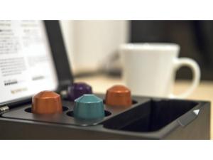 a tray with four different colored buttons next to a cup at Tmark City Hotel Sapporo Odori - Vacation STAY 85615v in Sapporo