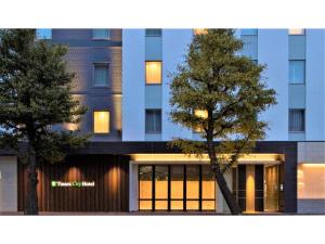 a building with a tree in front of it at Tmark City Hotel Sapporo Odori - Vacation STAY 85615v in Sapporo