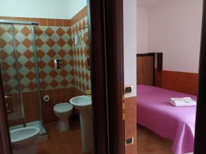 a bathroom with a bed and a toilet and a sink at Residenza Sant'Andrea in Campobasso