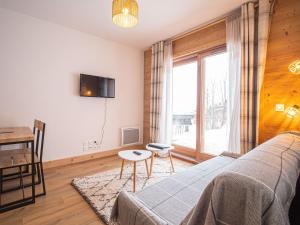 a bedroom with a bed and a table and a window at Appartement Valmorel, 2 pièces, 4 personnes - FR-1-356-413 in Valmorel