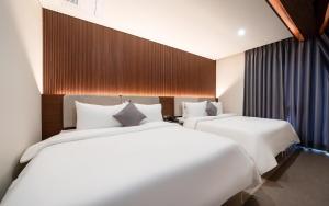 Ένα ή περισσότερα κρεβάτια σε δωμάτιο στο Hound Hotel Gijang Osiria