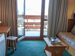 a hotel room with a bed and a large window at Appartement Valmorel, 2 pièces, 4 personnes - FR-1-356-424 in Valmorel