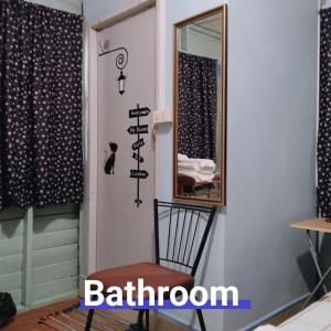 a room with a chair and a mirror at Ban Kru Ae HomeHostel in Bangkok +79 photos