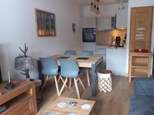 a kitchen and dining room with a table and chairs at Appartement Valmorel, 3 pièces, 5 personnes - FR-1-356-422 in Valmorel