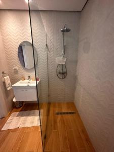 a bathroom with a shower and a sink at App avec jardin dans un hôtel in Gammarth