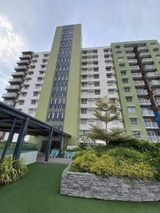 a large building with a tree in front of it at 6F Balcony View Studio Mesatierra Garden Residences in Davao City