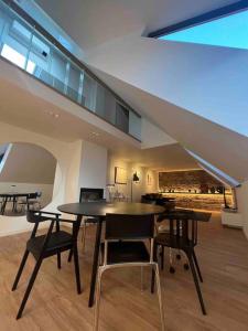 a dining room with a table and chairs in a house at KAUNAS ATTIC, Apartment in the heart of Kaunas in Kaunas