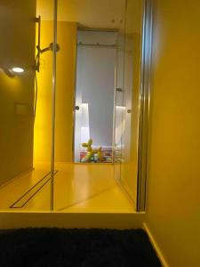 a mirror in a room with a yellow wall at KAUNAS ATTIC, Apartment in the heart of Kaunas in Kaunas