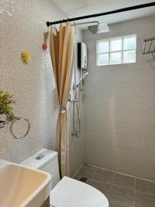 a bathroom with a shower with a toilet and a sink at BLUE OCEAN BOUTIQUE HOTEL - Boracay Island in Boracay