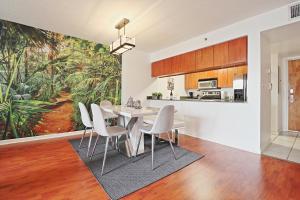 a kitchen and dining room with a table and chairs at Upscale Apartment in the Heart of Brickell in Miami