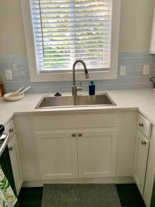 a kitchen with a sink and a window at StA Hideaway - Upper Unit Apt Minutes From Beach in St. Augustine