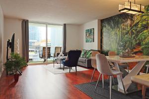 a living room with a couch and a table and chairs at Upscale Apartment in the Heart of Brickell in Miami +37 photos