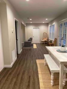 a living room with a table and a couch at StA Hideaway - Upper Unit Apt Minutes From Beach in Saint Augustine