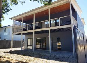 an exterior view of a house with balconies at Normanville Getaway House in Normanville