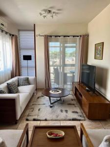 a living room with a couch and a tv at Mahajanga Residences in Mahajanga +4 photos