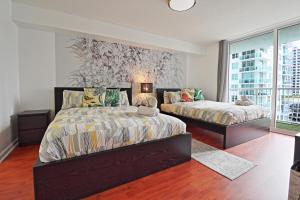 a bedroom with two beds and a window at Upscale Apartment in the Heart of Brickell in Miami