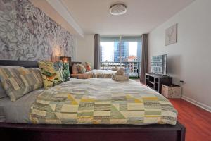 a bedroom with a large bed and a couch at Upscale Apartment in the Heart of Brickell in Miami