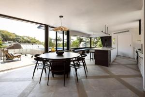a kitchen and dining room with a table and chairs at Moonrise & Starfall in Byron Bay