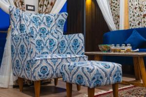 a blue chair with a pillow and a table at Skyview by Empyrean in Patnitop