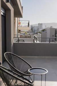 Un balcón con una silla y una mesa en ID Residences 102 en Volos