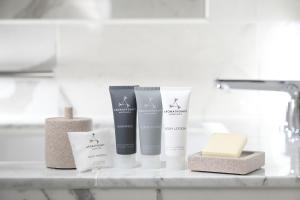 a shelf with three products on a bathroom counter at JW Marriott Hotel Nara in Nara