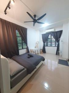 a bedroom with a bed and a ceiling fan at 3 Storey Bangalow near Spice Arena & Queensbay Mall in Bayan Lepas