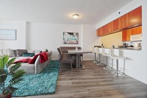 a living room with a couch and a table and chairs at Upscale Apartment in the Heart of Brickell in Miami