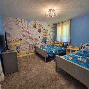 a bedroom with two beds and a wall with a hello kitty mural at Winterfield Storey Lakeview 4173 in Kissimmee