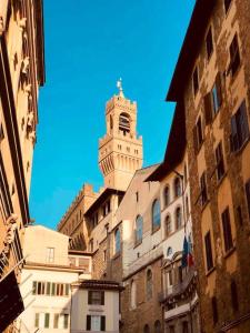 a tall building with a clock tower on top of it at signoria flat 5* centro storico in Florence