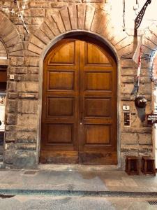a large wooden door in a stone building at signoria flat 5* centro storico in Florence