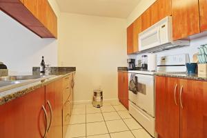 a kitchen with a sink and a stove at Upscale Apartment in the Heart of Brickell in Miami