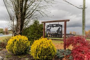 a park with a playground in the middle of some bushes at Farm House - L&S Farms in Chilliwack