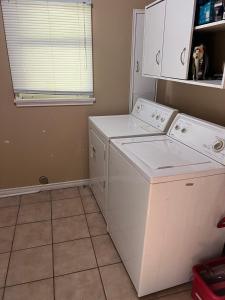 a laundry room with a washer and dryer at Farm House - L&S Farms in Chilliwack