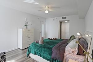 a white bedroom with a bed and a dresser at Upscale Apartment in the Heart of Brickell in Miami
