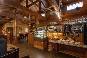 a restaurant with a counter in a wooden building at NEW！パノラマオーシャンビューのテラスジャグジーは圧巻。新築２階建て吹抜け天井リビングは開放感抜群 in Sesoko