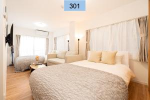 sypialnia z łóżkiem, kanapą i krzesłem w obiekcie Shinjuku area/Family-apartment/4 min to Subway w Tokio