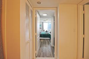 a hallway leading to a bedroom with a bed at Upscale Apartment in the Heart of Brickell in Miami