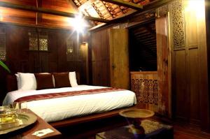 Postel nebo postele na pokoji v ubytování Terrapuri Heritage Village, Penarik