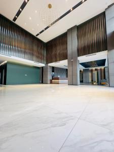 a large hall with a large white floor and a ceiling at K Avenue by BeMy guest in Kota Kinabalu