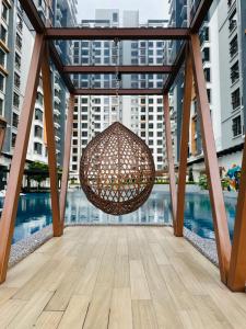a chandelier hanging from a balcony with buildings at K Avenue by BeMy guest in Kota Kinabalu