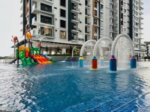 a swimming pool with a water park with a playground at K Avenue by BeMy guest in Kota Kinabalu